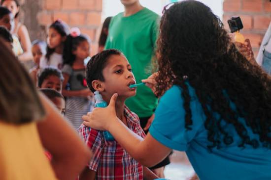 Adventist Medical Work in Community A woman provides care for a little boy, illustrating how Adventist medical missionaries can serve their communities.