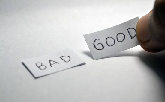 Two strips of paper with the words bad and good written on them Two strips of paper with the words