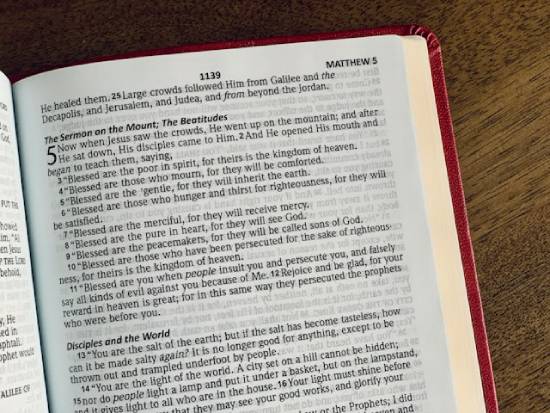 Bible open to the Beatitudes found in Matthew 5 A Bible opened to the story of The Beatitudes in the book of Matthew.