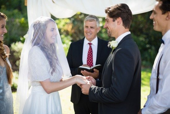 Wedding Ceremony A couple standing before a minister and holding hands during their wedding ceremony