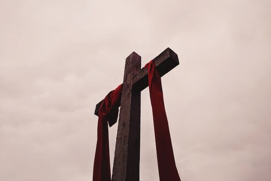 Cross Jesus Good Friday A cross with a red cloth draped over it to represent Jesus' death on Good Friday