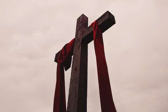 Cross of Jesus A cross with a red cloth draped around it, representing Jesus' death for us