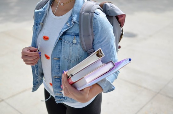 Carrying Books A young woman carrying books for canvassing