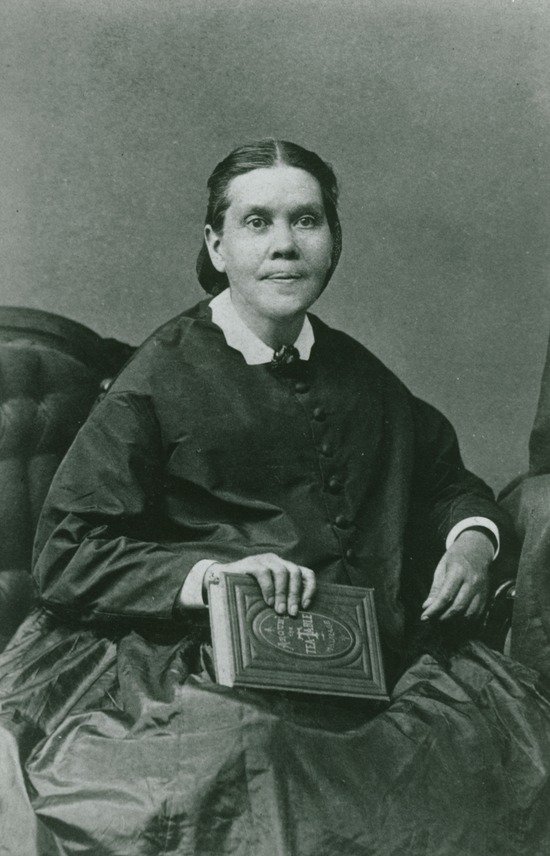 A portrait of Ellen White holding a book.