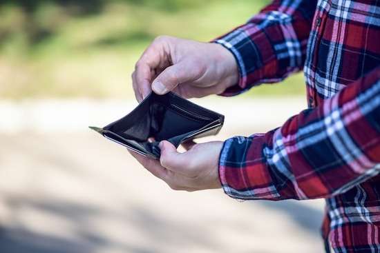 Empty Wallet Financial Struggles Hands hold open an empty wallet, suggesting financial struggles like those that Ellen and James White experienced