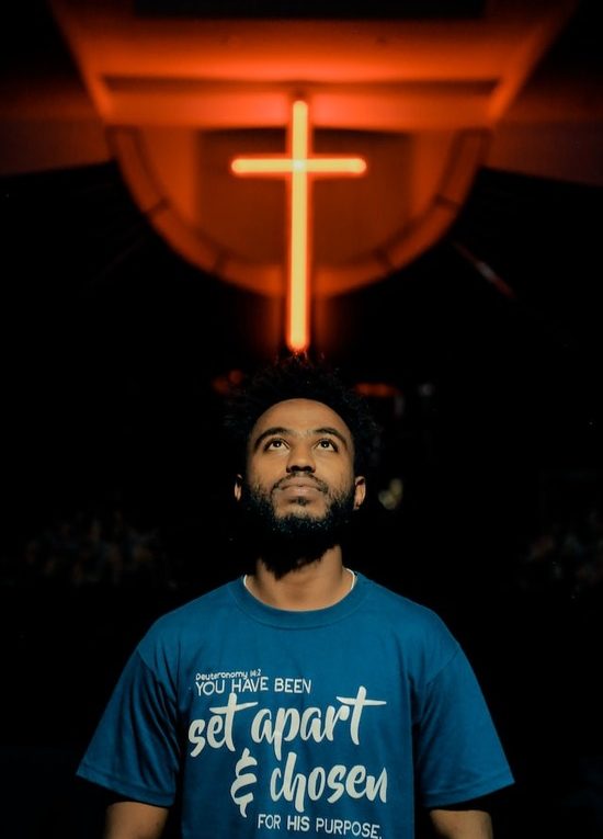 Glowing Cross A man looking up at the cross and receiving forgiveness of sins from Jesus