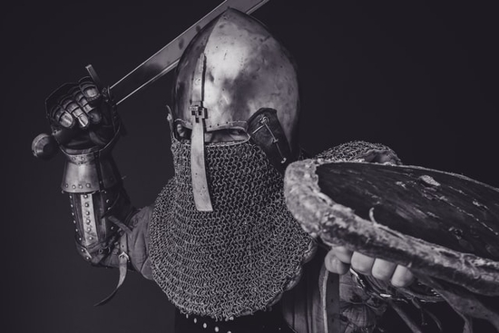 Soldier in battle armor with drawn sword Soldier with battle armor in posture of attack as we learn what does the armor of God mean to us in our practical daily life.