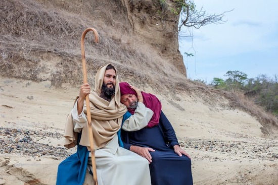 Jesus with a man needing help Jesus sitting with a man and putting his arm around him in comfort