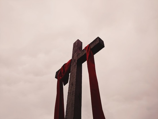 Cross Symbol A cross with a red cloth draped over it