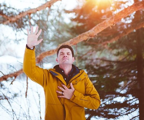 A man raising his hand in prayer and worship