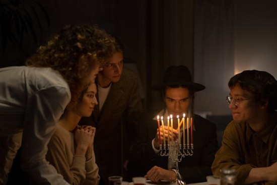 Modern day Jews lighting menorah candles as part of their Sabbath observance