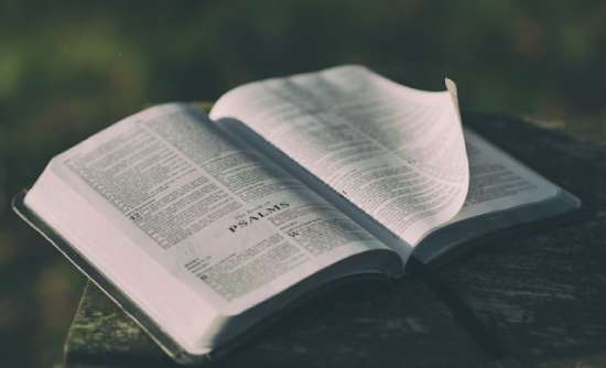 Book of psalms A Bible lays open to the book of Psalms as the wind gently turns a page.
