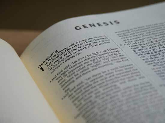 Bible open to Genesis 1:1 A Bible open to Genesis 1, where the Creation story is documented.
