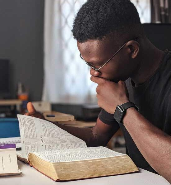 Man reading Bible Man studying Bible as Adventists believe reading & studying the Bible is key to growing relationship with God